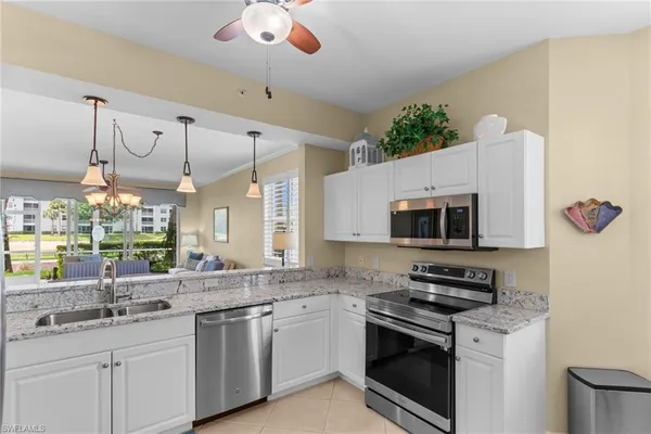 a kitchen with stainless steel appliances granite countertop a sink and a stove