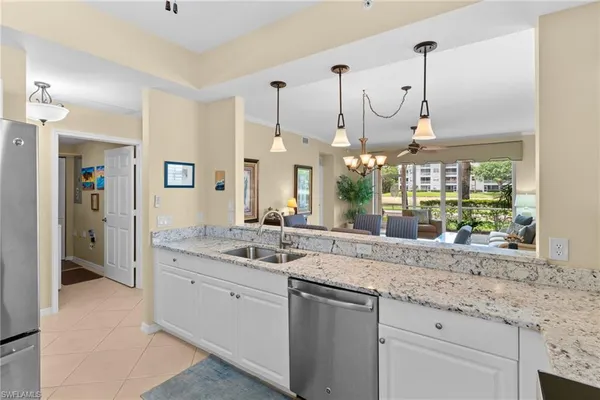 a bathroom with a granite countertop sink and a large mirror