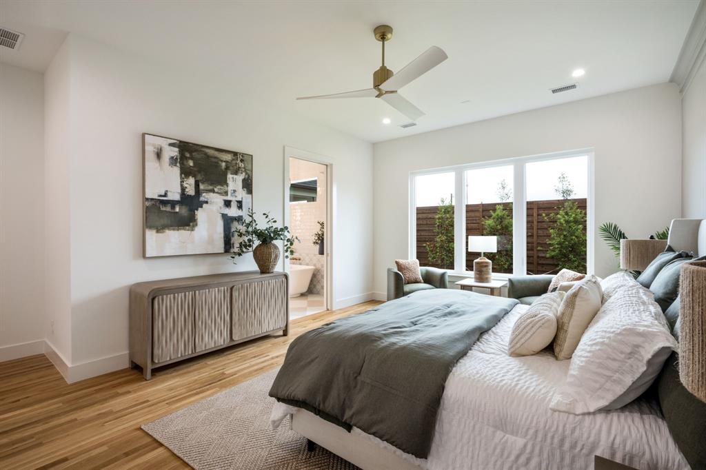 3304 Ferguson Road Grapevine, TX 76092 - Photo 23 of 38 Spacious bedroom with wood-finish flooring and a contemporary gold-finish ceiling fan