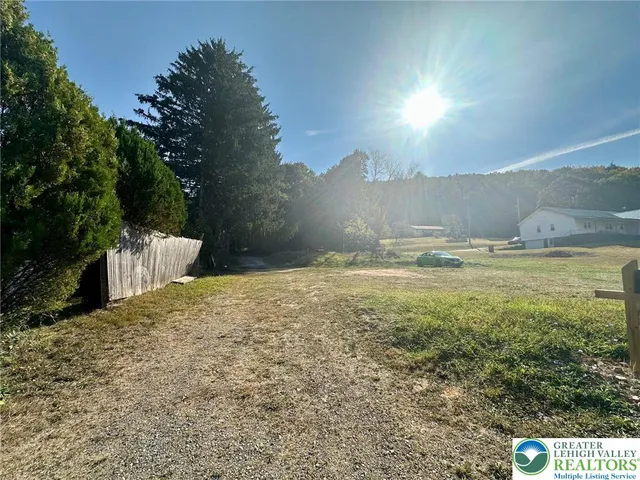 a view of a yard with an ocean