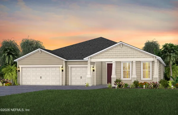 a view of a yard in front of a house with plants and large tree