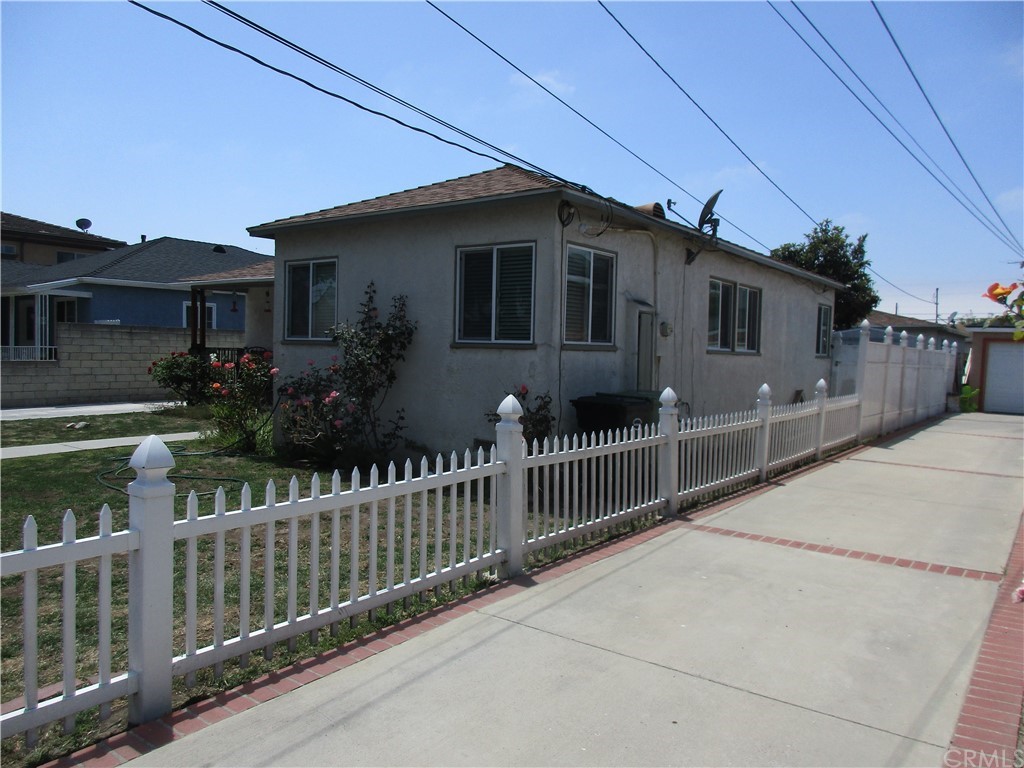 a front view of house with wooden fence