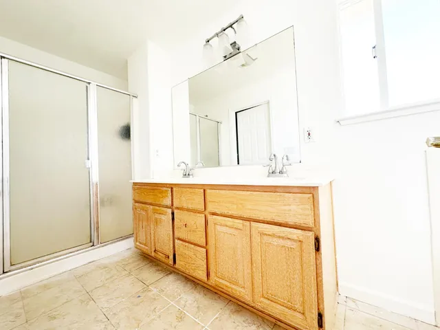 a bathroom with a double vanity sink mirror and