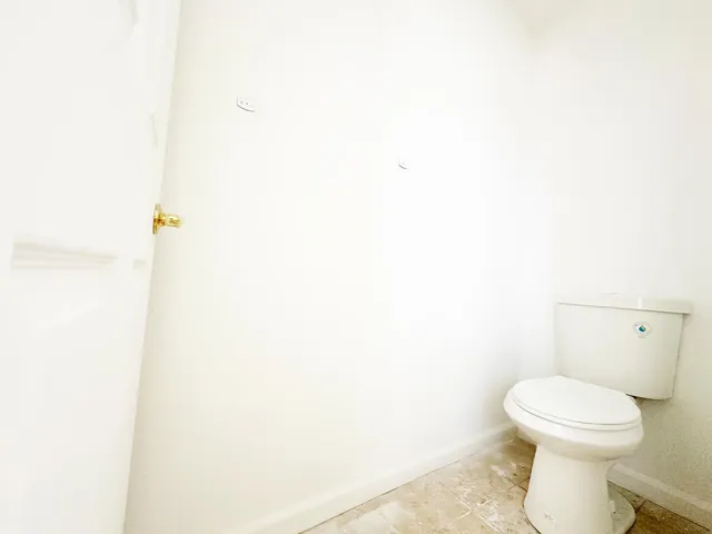 a white toilet sitting next to a white sink