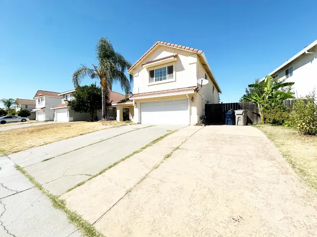 a view of a house with palm trees