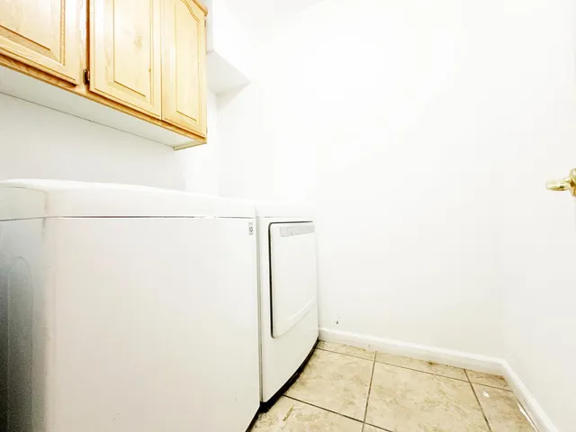 a view of a white house with a yard