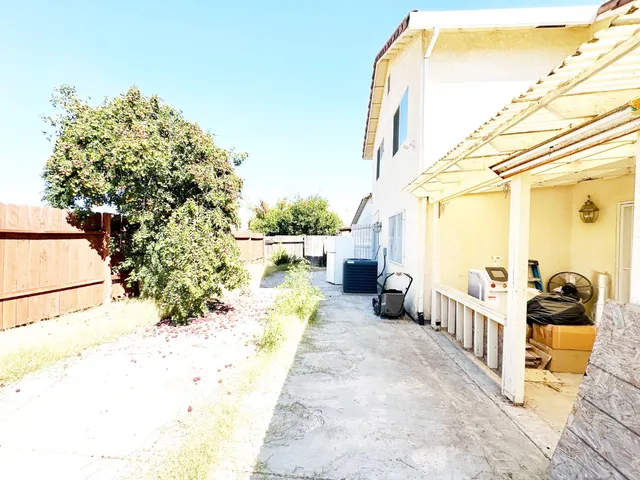 a view of a white house with a yard