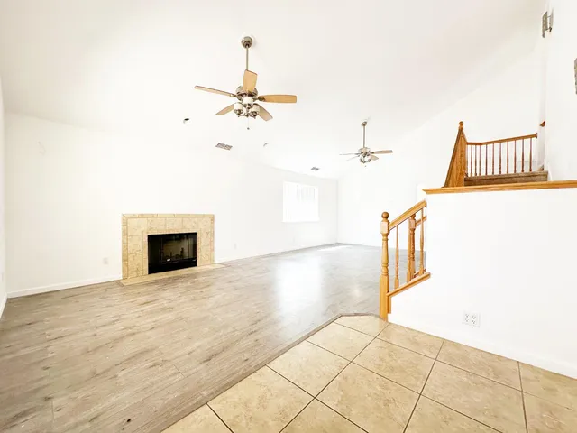 a view of a livingroom with wooden floor and a ceiling fan