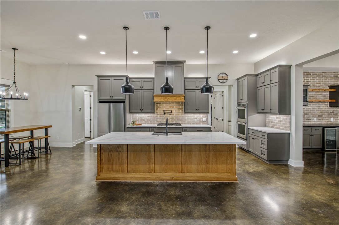 7532 Mary's Way Bryan, TX 77808 - Photo 15 of 38 a view of kitchen with stainless steel appliances granite countertop a stove a sink a refrigerator and a dining table