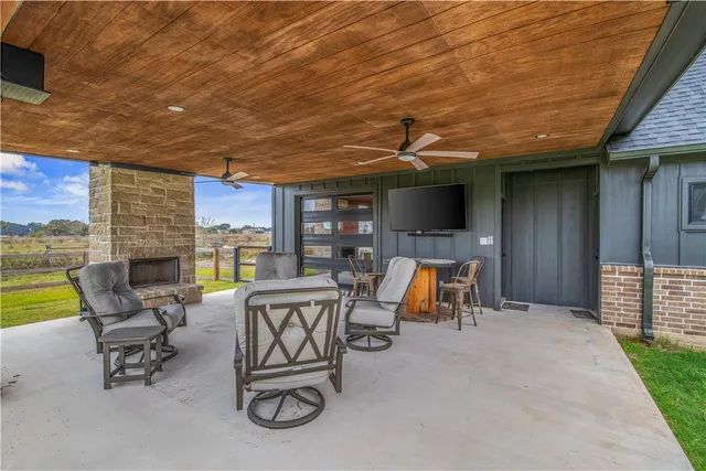 a view of a patio with chairs and table in patio