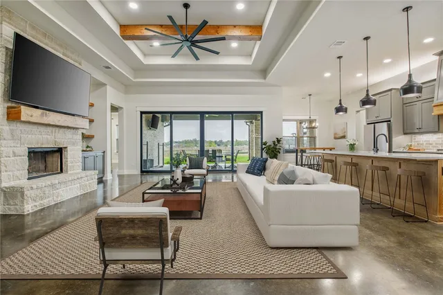 a living room with furniture a flat screen tv and a fireplace