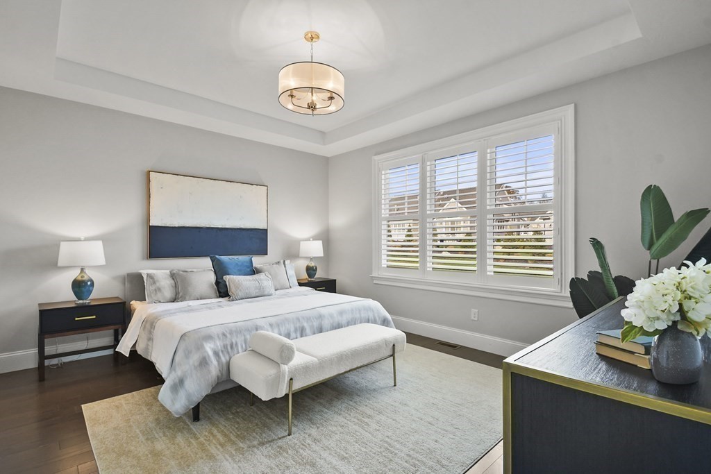 9 Eagle Lane, Unit 9 Framingham, MA 01701 - Photo 14 of 42 a bedroom with a bed and a chandelier