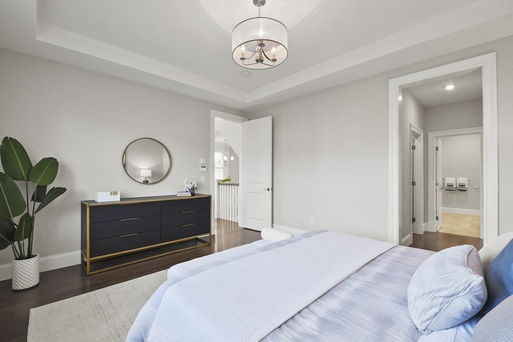 9 Eagle Lane, Unit 9 Framingham, MA 01701 - Photo 15 of 42 a bedroom with bed and wooden floor