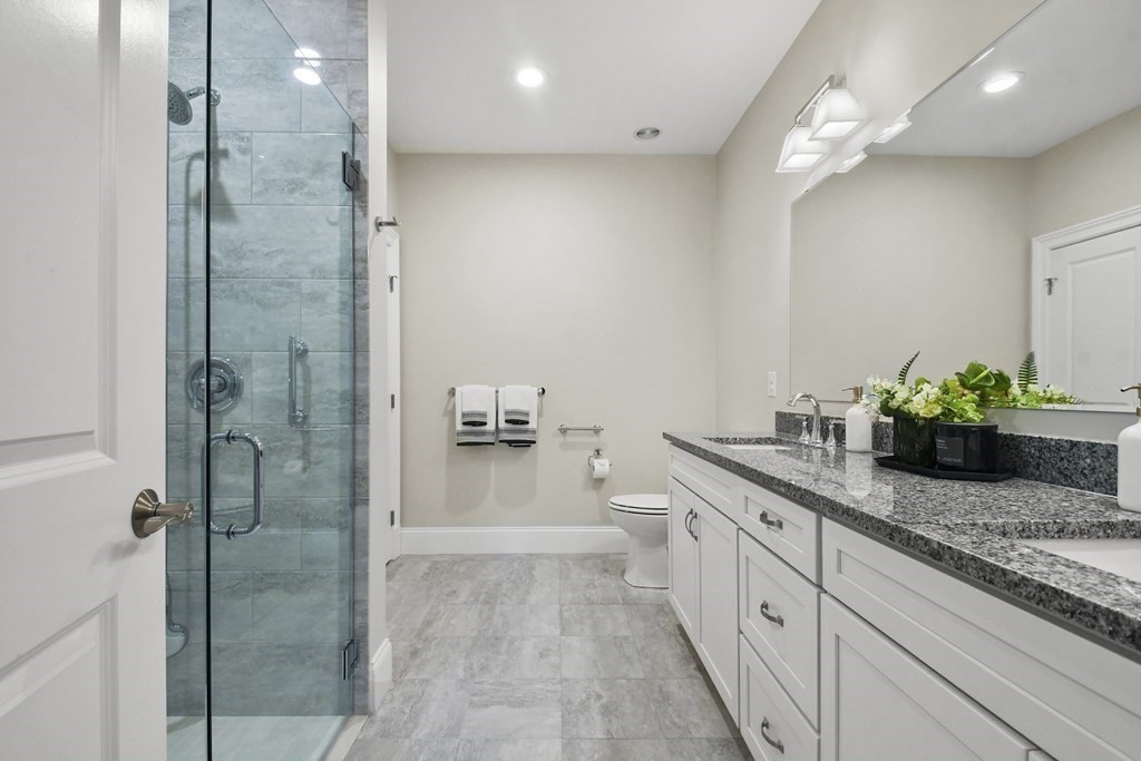 9 Eagle Lane, Unit 9 Framingham, MA 01701 - Photo 16 of 42 a spacious bathroom with a granite countertop sink a toilet and shower
