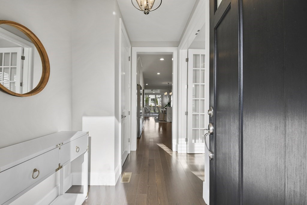 9 Eagle Lane, Unit 9 Framingham, MA 01701 - Photo 2 of 42 a view of a hallway with wooden floor and entryway
