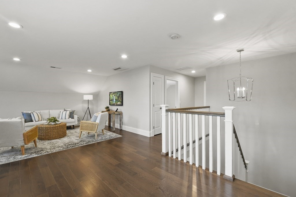 9 Eagle Lane, Unit 9 Framingham, MA 01701 - Photo 21 of 42 a living room with furniture and a wooden floor