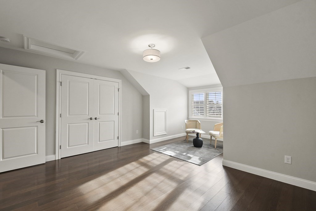 9 Eagle Lane, Unit 9 Framingham, MA 01701 - Photo 25 of 42 a bedroom with a bed and wooden floor