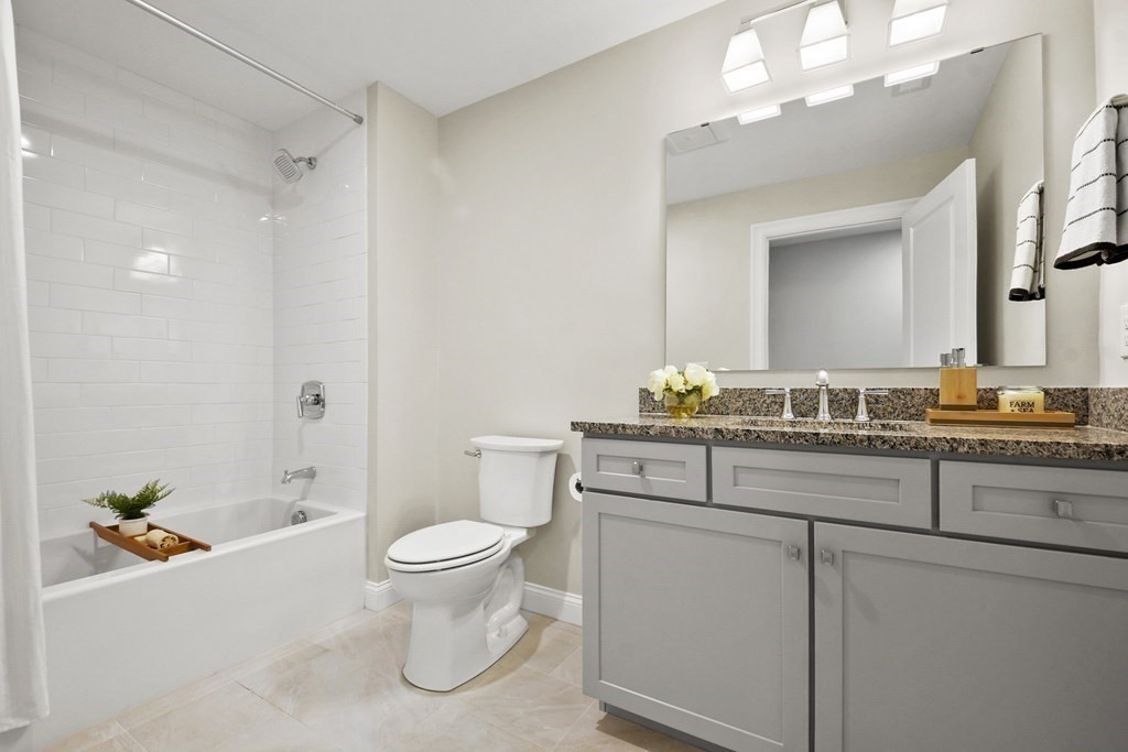 9 Eagle Lane, Unit 9 Framingham, MA 01701 - Photo 27 of 42 a bathroom with a sink a toilet and a mirror