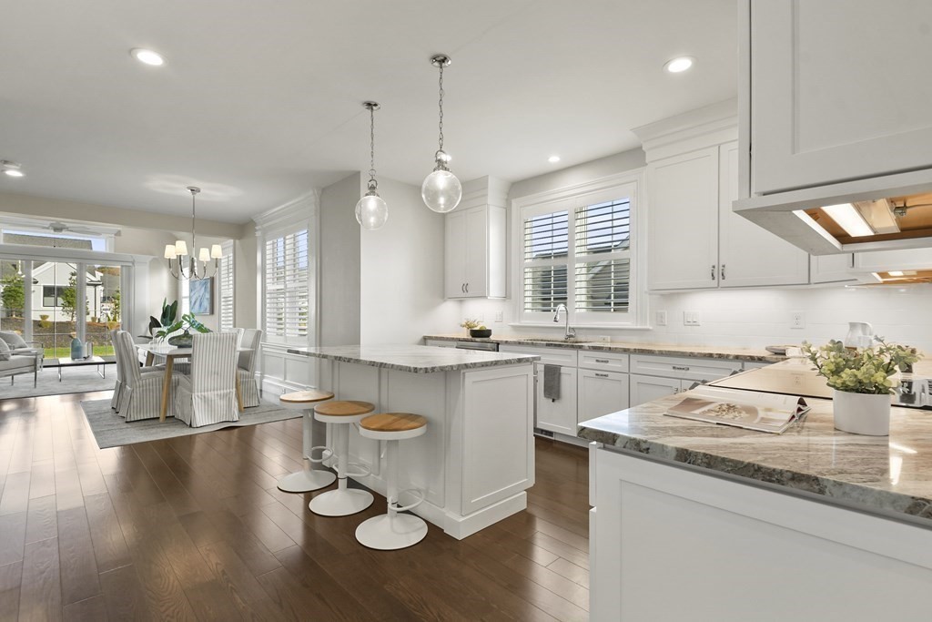 9 Eagle Lane, Unit 9 Framingham, MA 01701 - Photo 3 of 42 a kitchen with a sink dishwasher stove and white cabinets with wooden floor