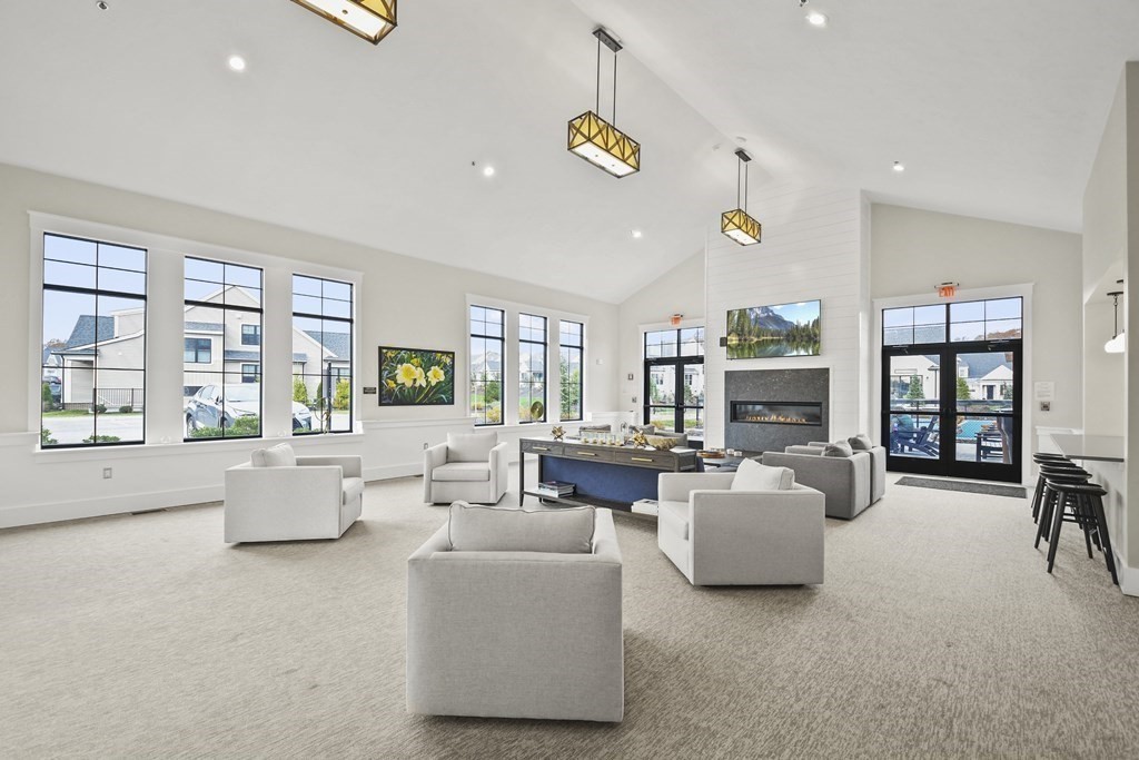 9 Eagle Lane, Unit 9 Framingham, MA 01701 - Photo 35 of 42 a living room with fireplace furniture and floor to ceiling window