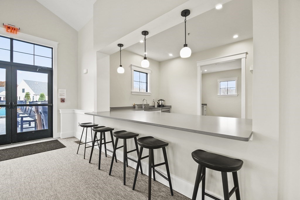9 Eagle Lane, Unit 9 Framingham, MA 01701 - Photo 36 of 42 a view of a dining room with furniture and a chandelier