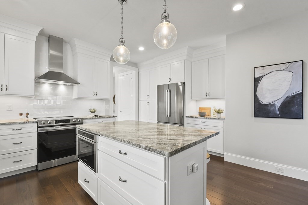 9 Eagle Lane, Unit 9 Framingham, MA 01701 - Photo 4 of 42 a kitchen with stainless steel appliances granite countertop a sink stove and refrigerator