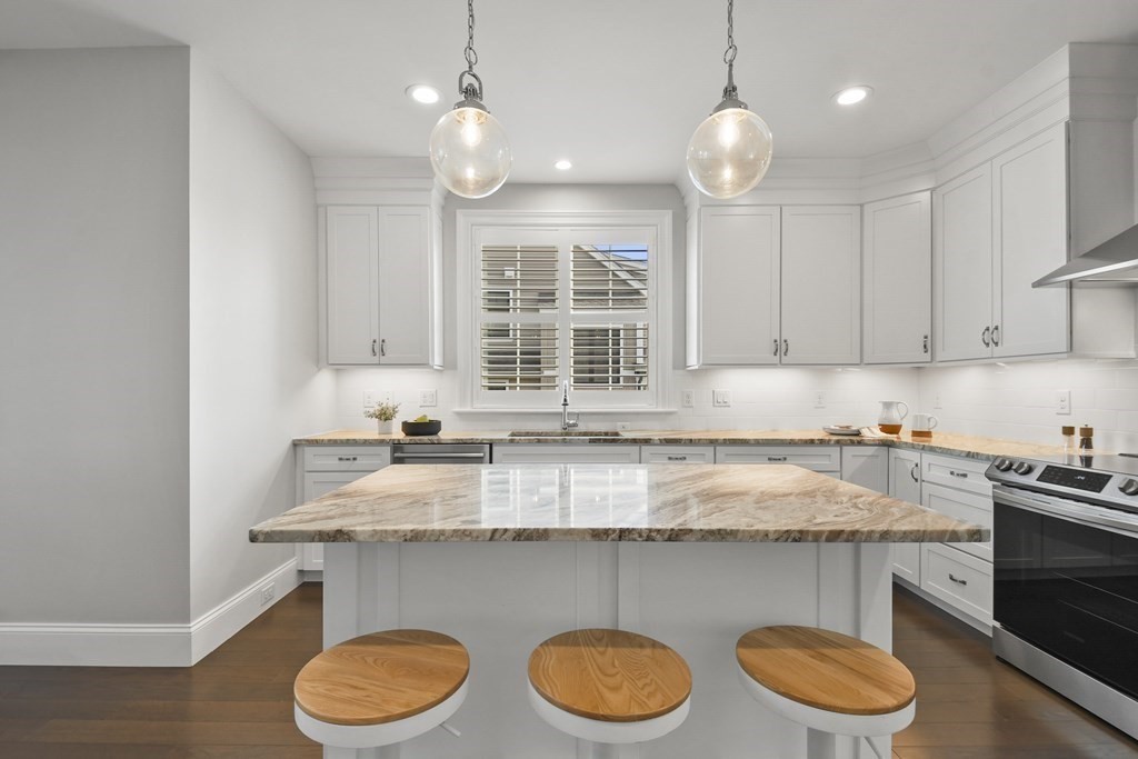9 Eagle Lane, Unit 9 Framingham, MA 01701 - Photo 5 of 42 a kitchen with a sink a stove and cabinets