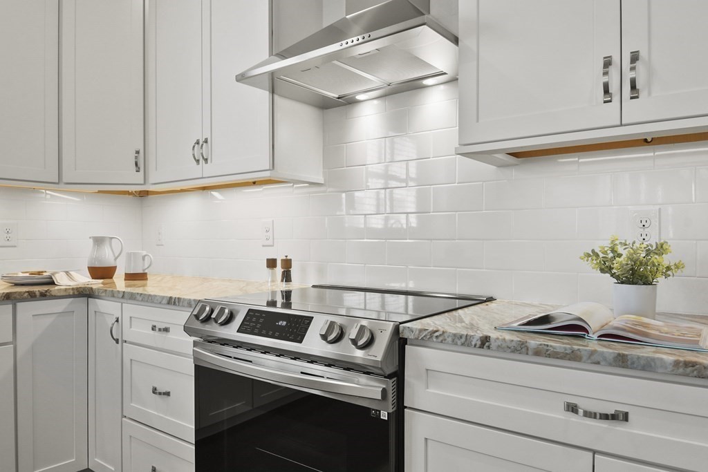 9 Eagle Lane, Unit 9 Framingham, MA 01701 - Photo 6 of 42 a kitchen with granite countertop white cabinets and white appliances
