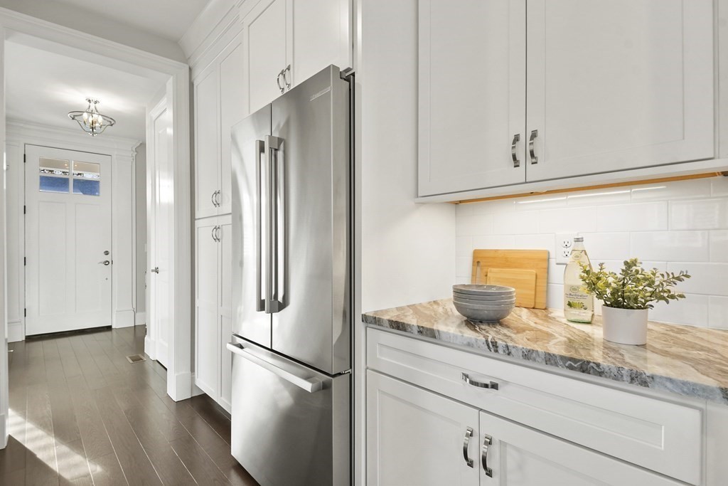 9 Eagle Lane, Unit 9 Framingham, MA 01701 - Photo 7 of 42 a kitchen with granite countertop stainless steel appliances a refrigerator and a counter space