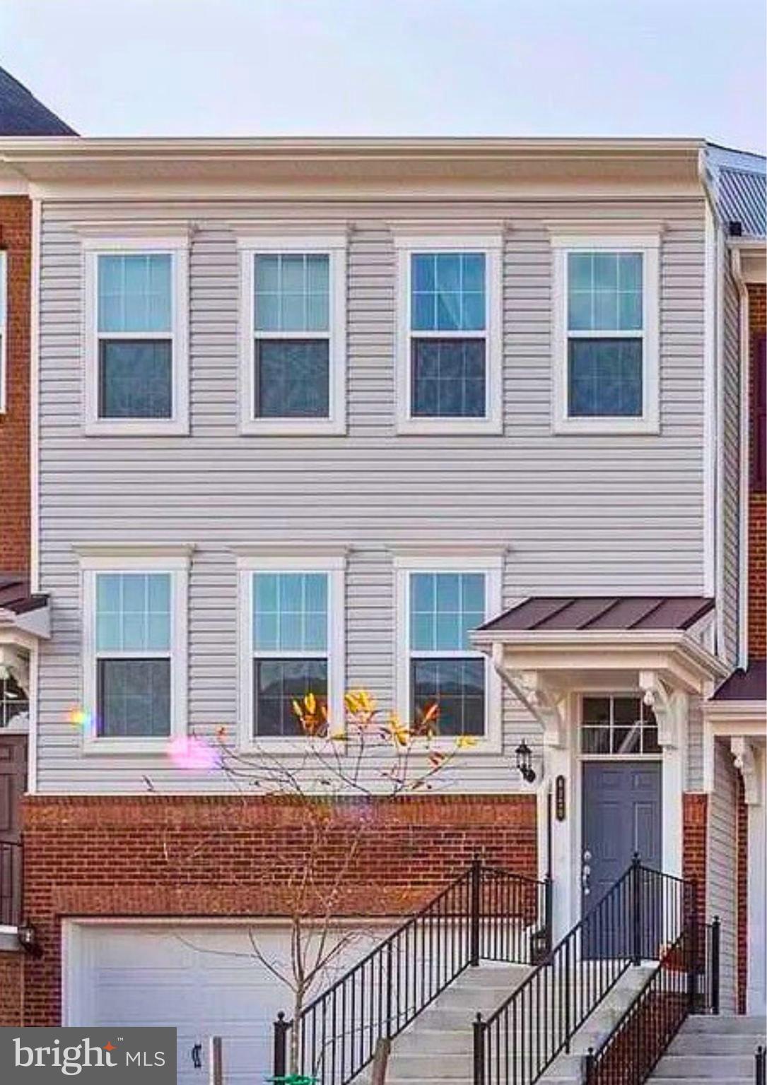 a view of a house with wooden deck and furniture