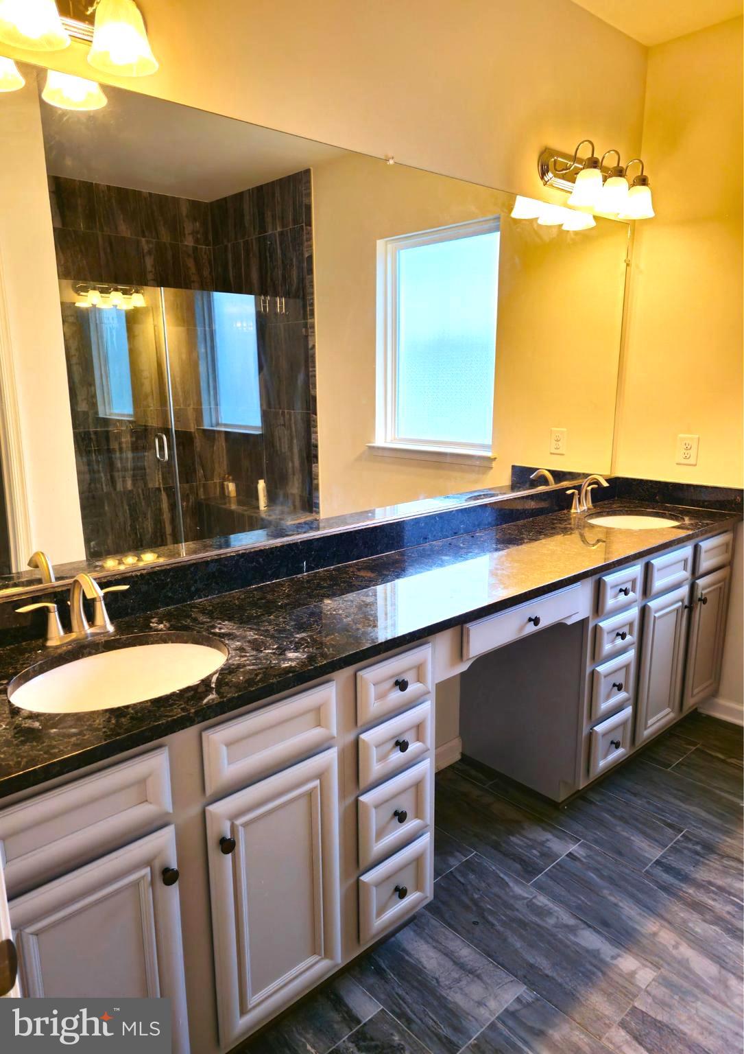 8120 Dalton Way Hanover, MD 21076 - Photo 14 of 22 a bathroom with a double vanity sink and a mirror