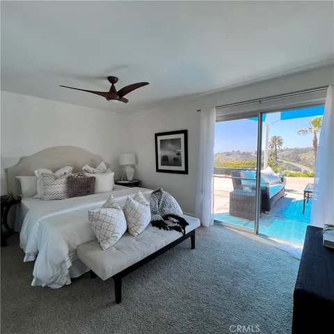 a spacious bedroom with a bed and large window
