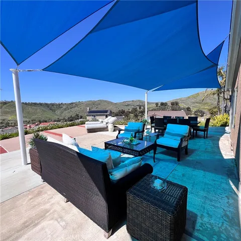 a view of an outdoor sitting area with furniture and umbrella