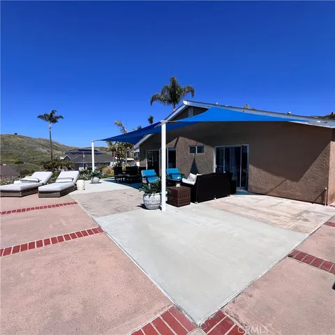 a view of a patio with table and chairs