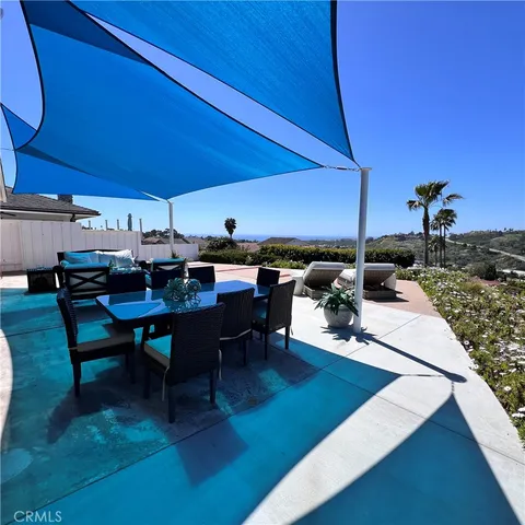 a view of a patio with table and chairs