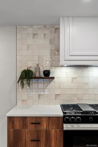 a kitchen with kitchen island granite countertop a sink stainless steel appliances and cabinets