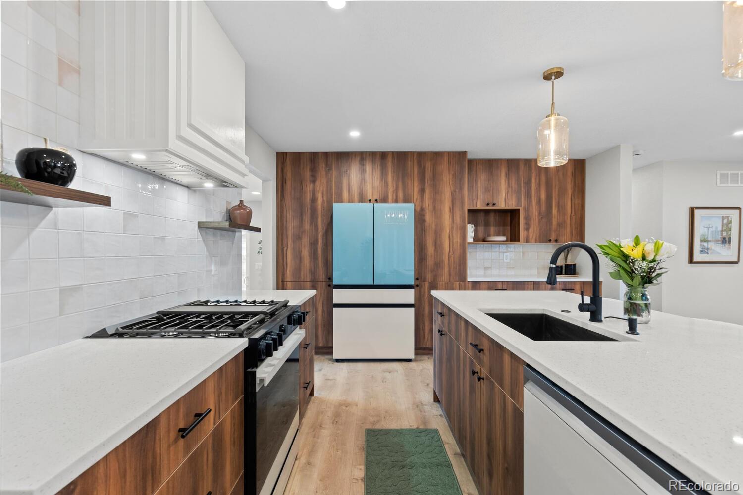 1711 South Forest Street Denver, CO 80222 - Photo 13 of 44 a kitchen with kitchen island granite countertop a sink stainless steel appliances and cabinets
