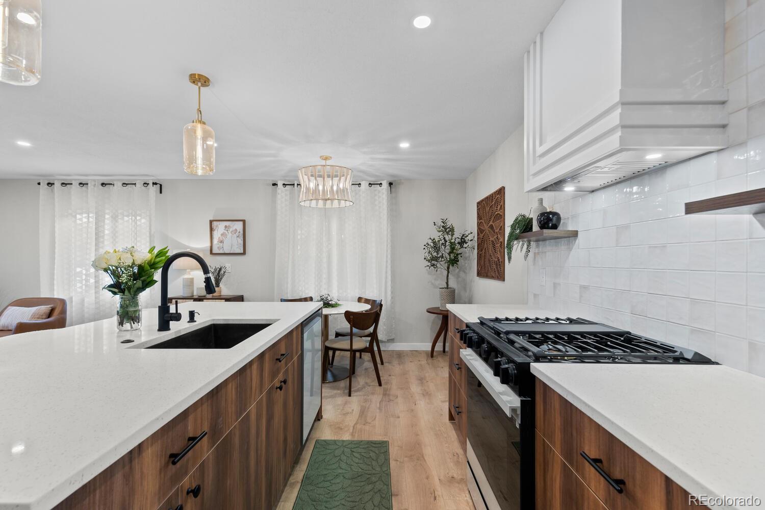 1711 South Forest Street Denver, CO 80222 - Photo 14 of 44 a kitchen with stainless steel appliances a sink stove and cabinets
