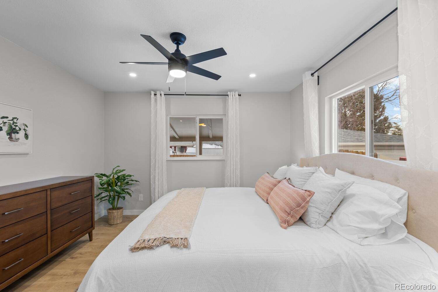 1711 South Forest Street Denver, CO 80222 - Photo 17 of 44 a bedroom with a large bed and a window