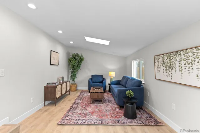 a living room with furniture window and wooden floor