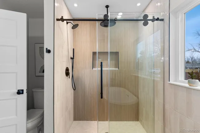 a bathroom with double vanity sinks and mirror