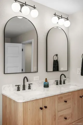 a bathroom with a sink and mirror