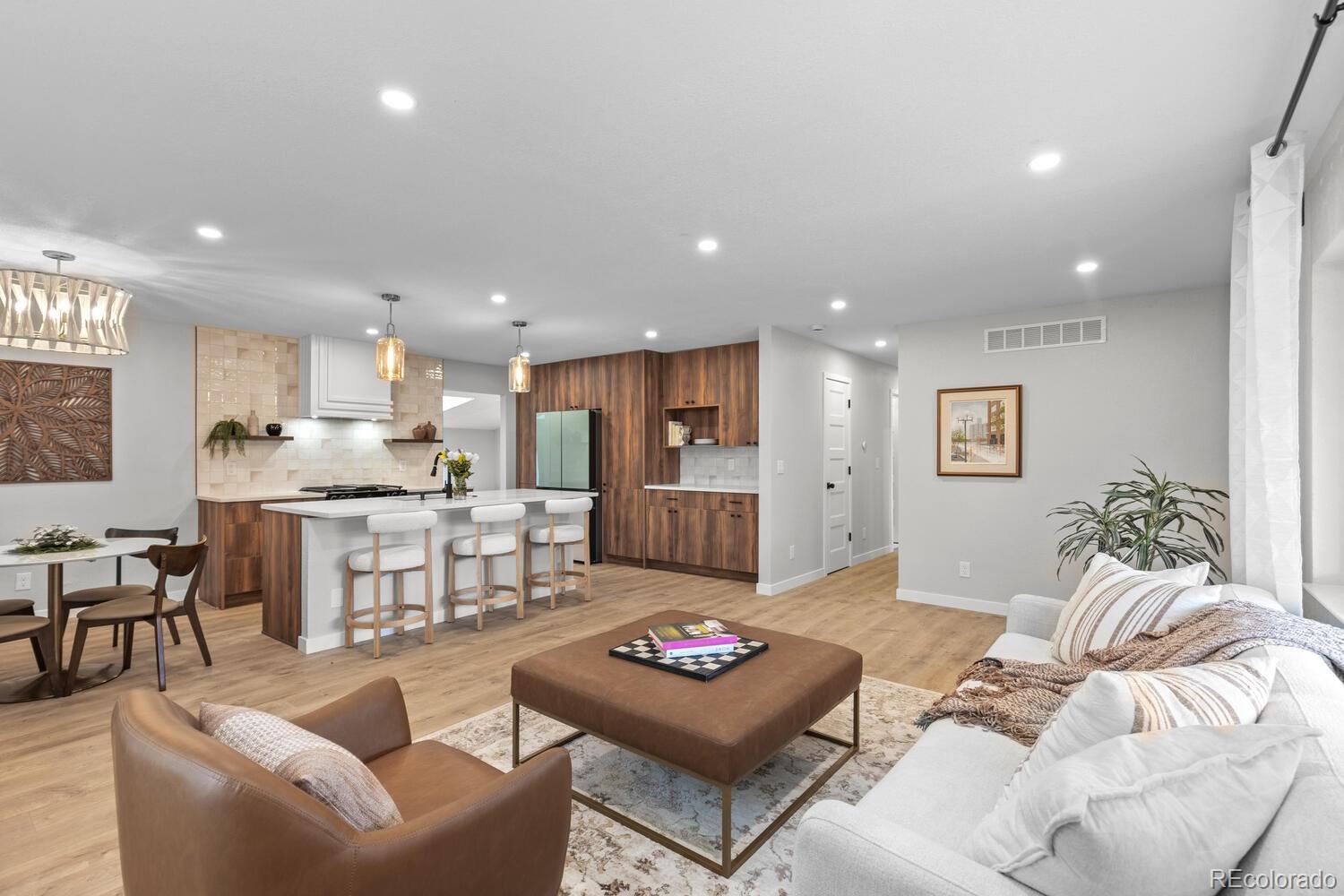 1711 South Forest Street Denver, CO 80222 - Photo 10 of 44 a living room with furniture and a dining table with kitchen view