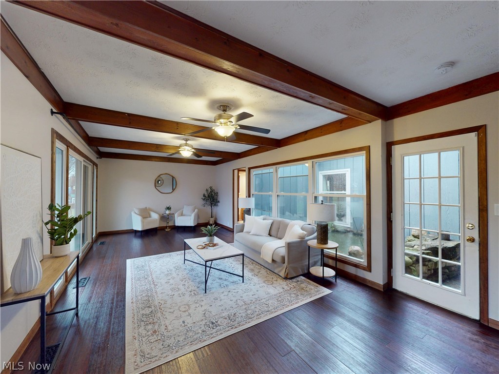 162 South Leavitt Road Amherst, OH 44001 - Photo 11 of 41 Living area featuring ceiling fan, dark wood finished floors, and beamed ceiling