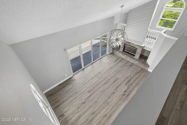 a view of kitchen with stainless steel appliances refrigerator stove microwave and cabinets