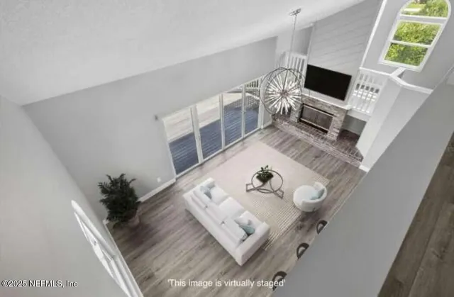 a living room with furniture a dining table a rug and a view of kitchen