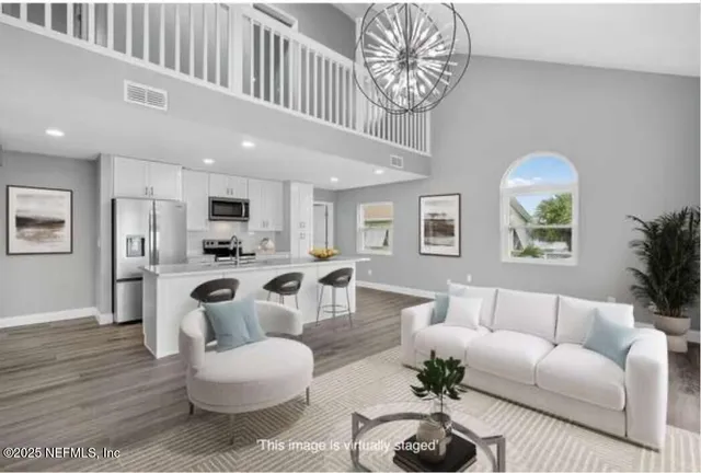 a large kitchen with a lot of counter space and wooden floor