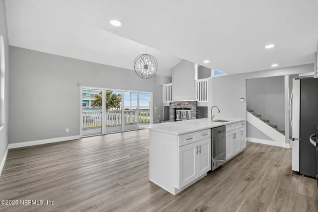 a kitchen with stainless steel appliances a refrigerator sink and microwave
