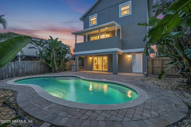 a view of a swimming pool in the backyard of house
