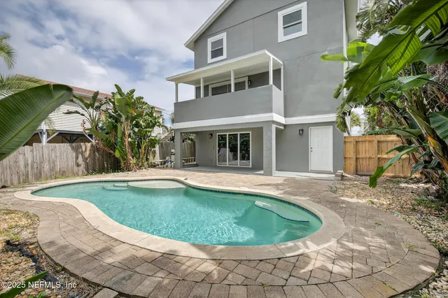 a view of a swimming pool with a yard